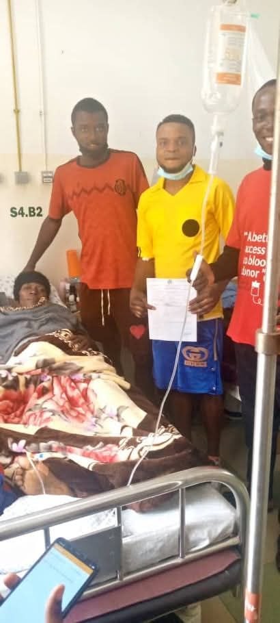 A patient in a hospital ward with an Ayodah volunteer and a donor holding the completed request form.